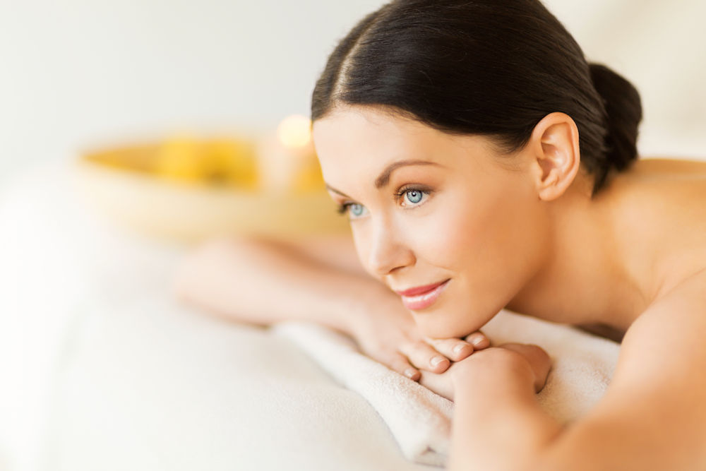 picture of woman in spa salon lying on the massage desk Superior Inn Grand Marais - The Spa Within